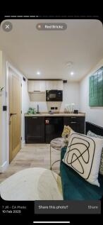 A modern, compact kitchen area featuring light ...