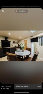 A modern kitchen featuring sleek black cabinetr...