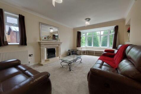 A cozy living room featuring comfortable leathe...
