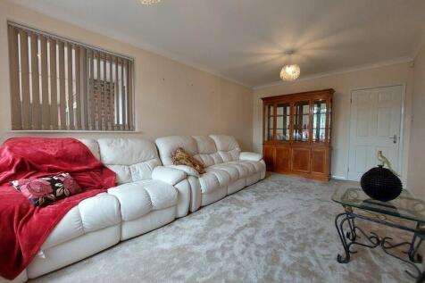 A cozy living room featuring comfortable white ...