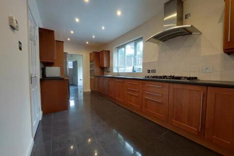 Bright and spacious kitchen featuring wooden ca...