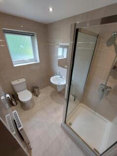 Bright and modern bathroom featuring a walk-in ...