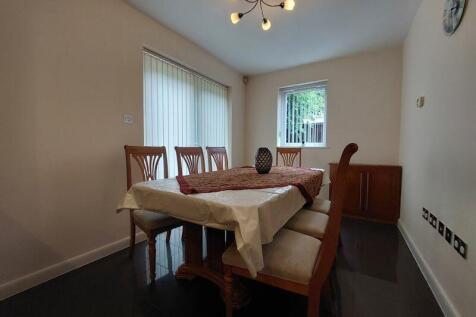 A neat and inviting dining room featuring a woo...