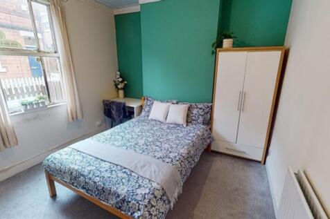This inviting double bedroom features a cozy be...