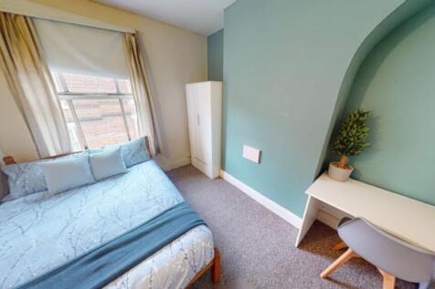 This charming double bedroom features a cozy be...