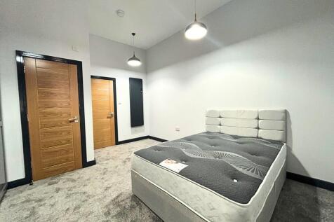 A modern master bedroom featuring a large doubl...