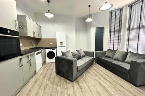 Bright, modern living room with comfortable gre...