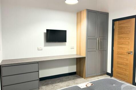 A modern, tidy double bedroom featuring a mount...