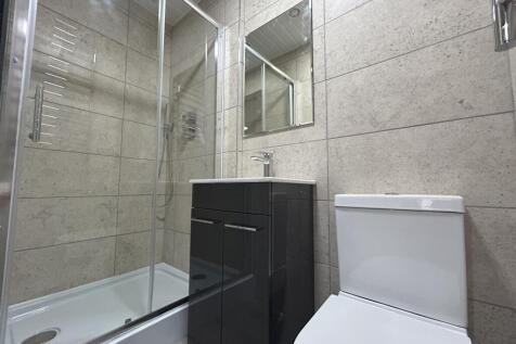 Modern bathroom featuring a sleek glass shower ...