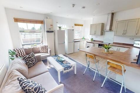 Bright and welcoming living room with a cozy so...