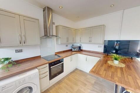 Bright and modern kitchen featuring light cabin...