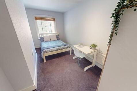 A clean and well-maintained toilet room with wh...