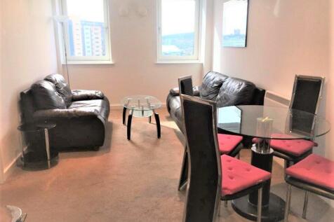 A bright living room featuring comfortable blac...
