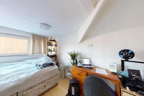 Bright double bedroom featuring a comfortable b...