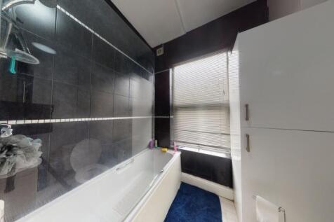 A modern bathroom suite featuring a bathtub wit...