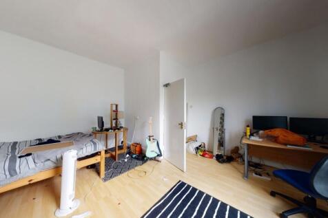 A bright and tidy single bedroom featuring a wo...