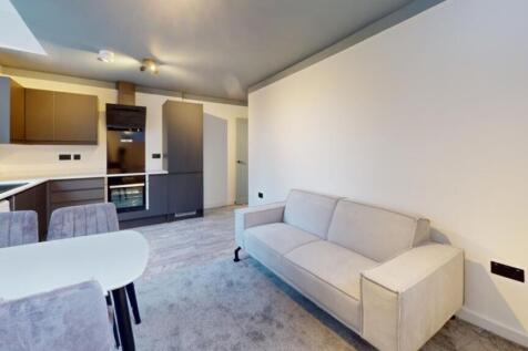 A spacious and modern living room featuring sty...