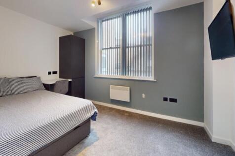 A spacious and well-lit double bedroom featurin...