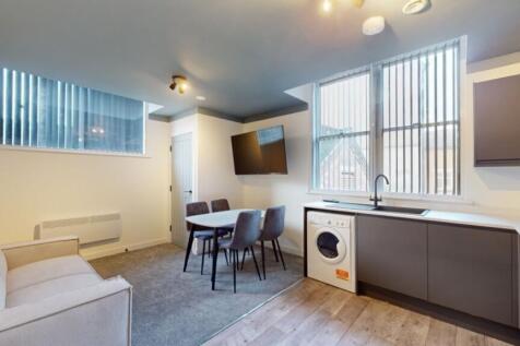 A bright and modern kitchenette with ample spac...