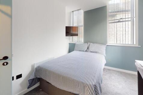 A stylish and inviting double bedroom with ampl...