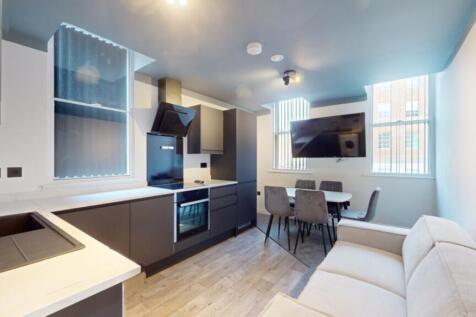 A modern and spacious kitchenette featuring lar...