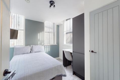 A bright and inviting double bedroom featuring ...