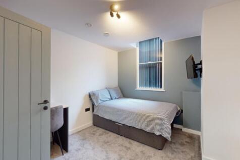 A modern and tidy double bedroom featuring ampl...