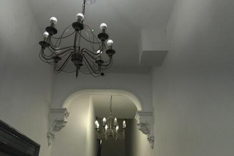A tastefully designed hallway featuring elegant...