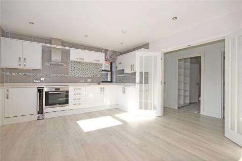 Bright and modern kitchen with sleek white cabi...