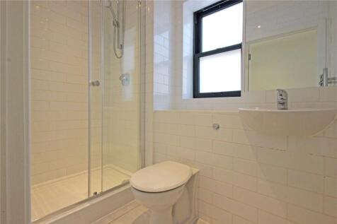 A clean and modern bathroom featuring a clear g...
