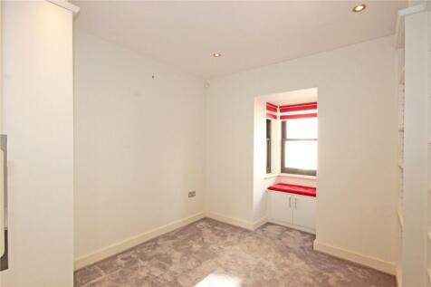 A clean and modern small room with neutral wall...