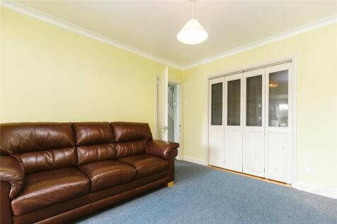 Bright living room featuring a comfortable brow...
