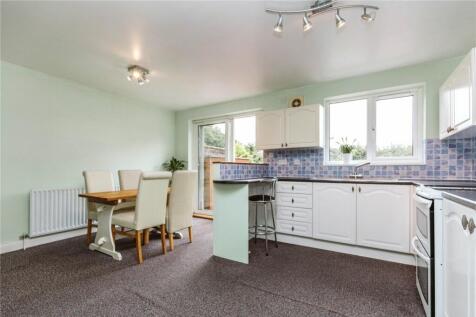 Bright and airy kitchen with ample natural ligh...