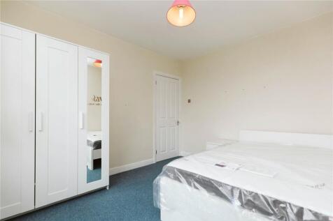 Bright and simple double bedroom featuring a la...