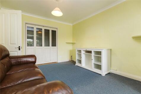 A cozy living room featuring a comfortable leat...