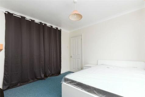 A simple and clean double bedroom featuring a d...