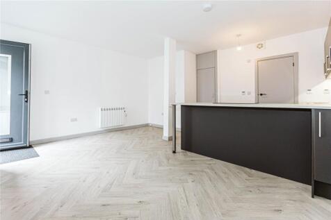 Bright and modern living room with ample natura...
