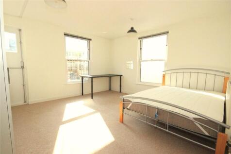 Bright and airy master bedroom featuring a spac...