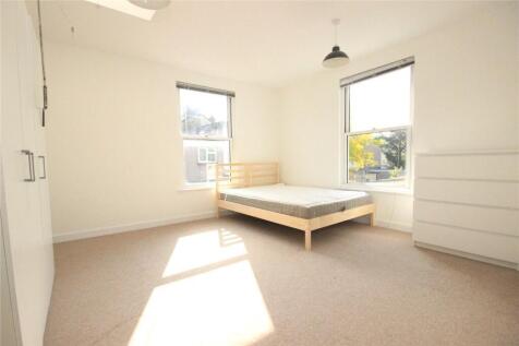 Bright and airy double bedroom featuring two la...