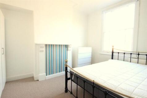 Bright and airy master bedroom featuring a larg...