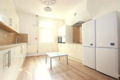 Bright and modern kitchen featuring sleek white...
