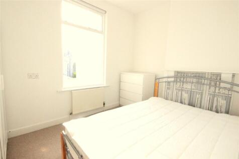 A bright and airy double bedroom featuring a la...