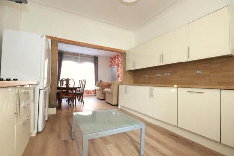 A bright and spacious kitchen with ample cabine...