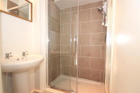 A modern bathroom featuring a sleek walk-in sho...