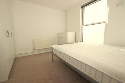 Bright and minimalistic bedroom featuring a com...