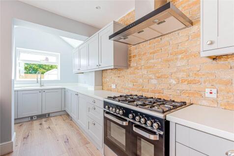 Bright and modern kitchen featuring a stylish b...