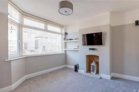 Bright and tidy living room featuring a large b...