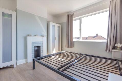 A bright and airy double bedroom featuring a la...