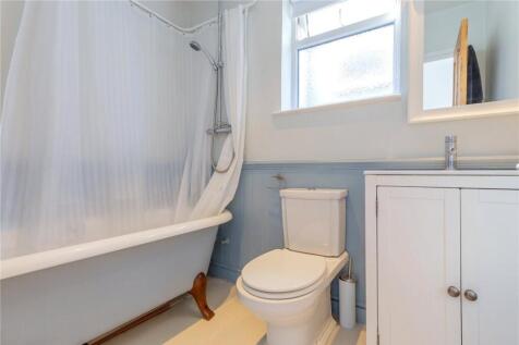 Bright and clean bathroom featuring a classic c...