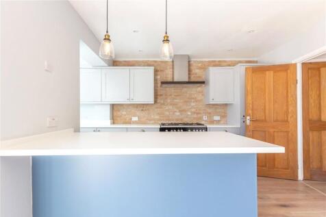 Bright modern kitchen featuring a spacious coun...